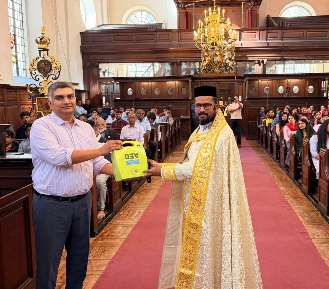 Dr. John Philip and Rev. Fr. P.J. Binu of St George’s Indian Orthodox Church in London with a ZOLL AED defibrillator donated by Defib Warehouse